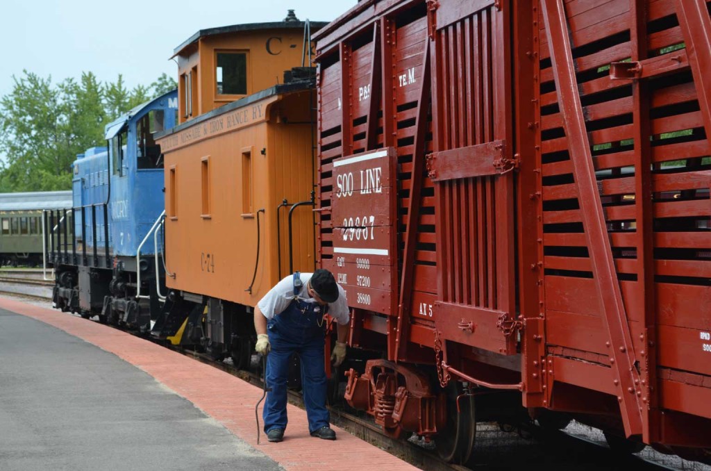 Trainman inspecting train.