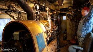 Approximately 10 ft long boiler inside the what was once a baggage room. A volunteer is monitoring boiler pressure gauges. Photo credited to Mid-Continent Railway Museum.