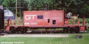 Red caboose with boxcar-like center and large platforms on both ends. It has a styled logo GT logo. MCRM reporting marks are spraypainted on next to its number, 75050.